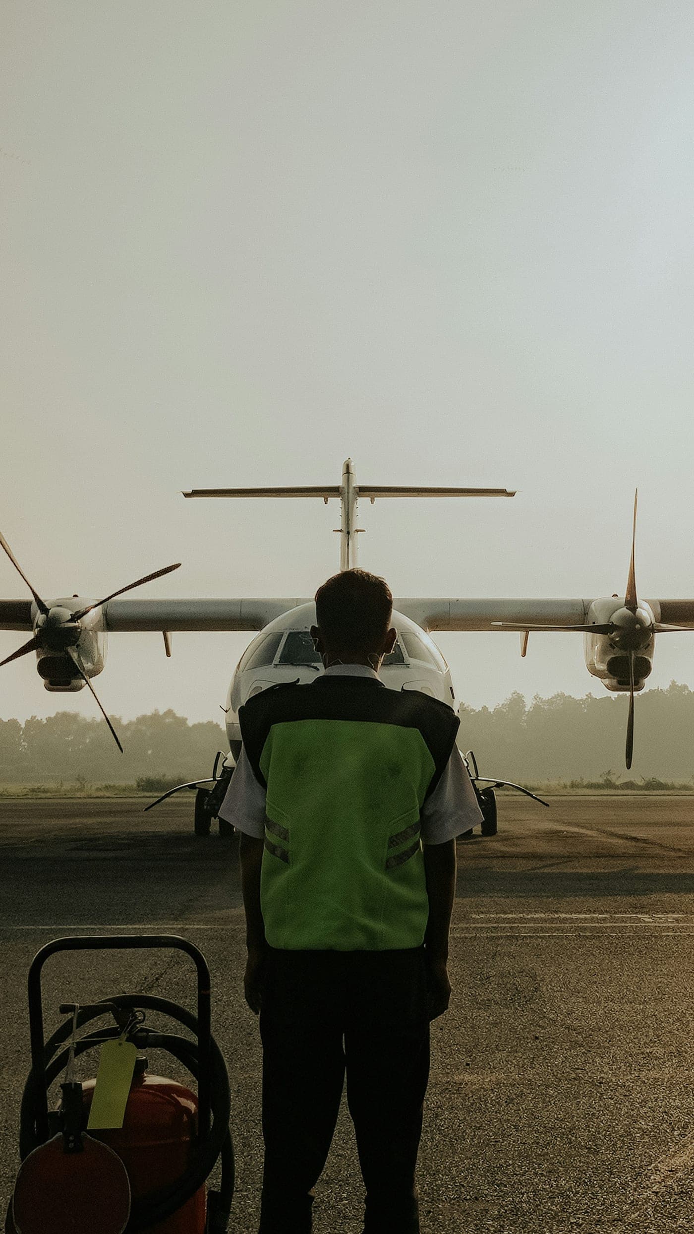 A technician performing a pre-flight walk around on the ramp