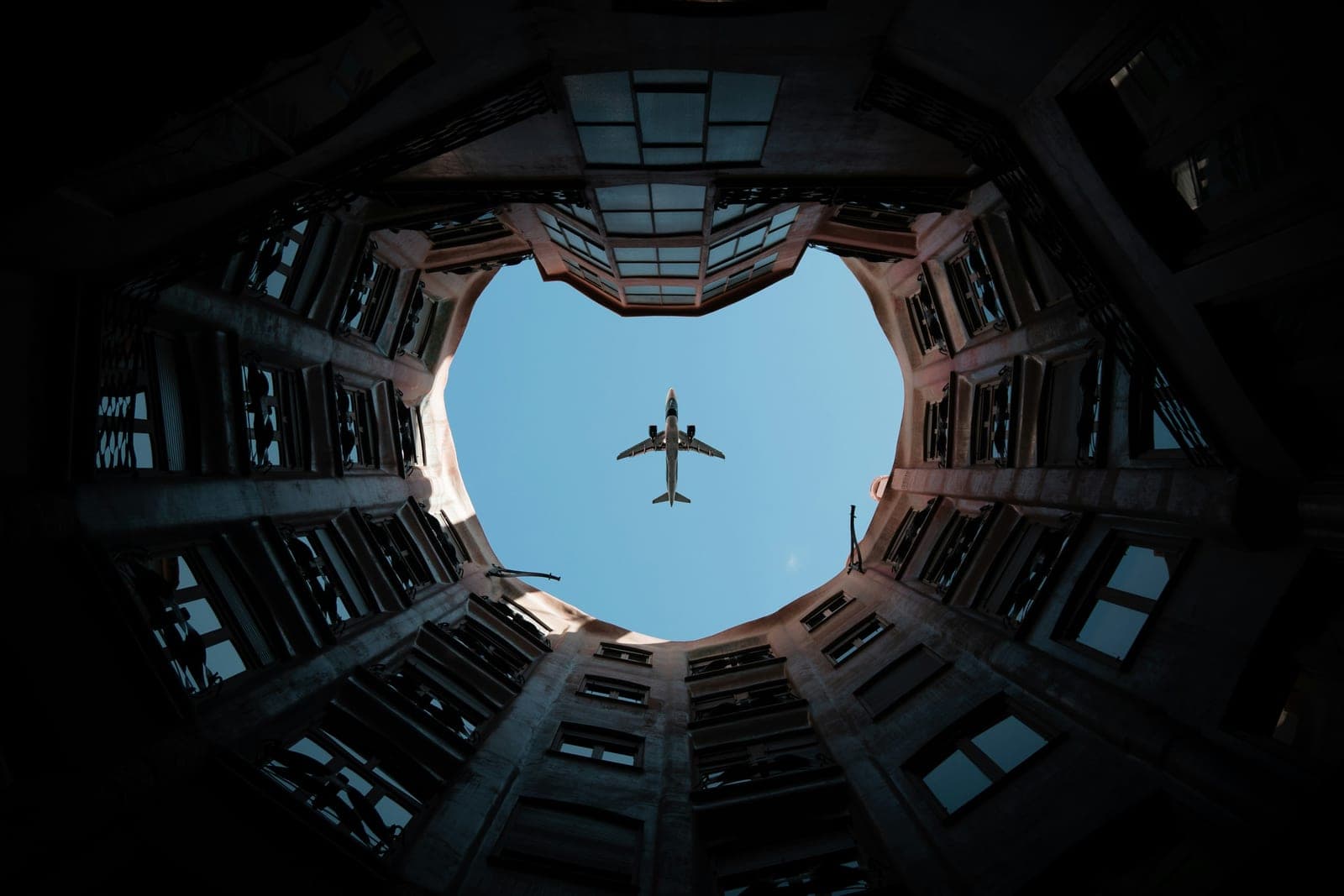 Looking up through an open hangar roof at an aircraft